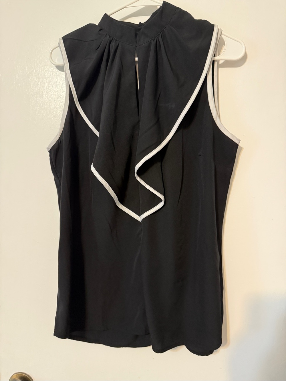 Sleeveless Black Ruffle-Front Blouse with White Trim